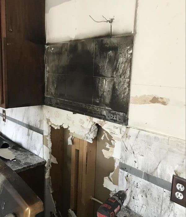 Soot covered wall in a kitchen.